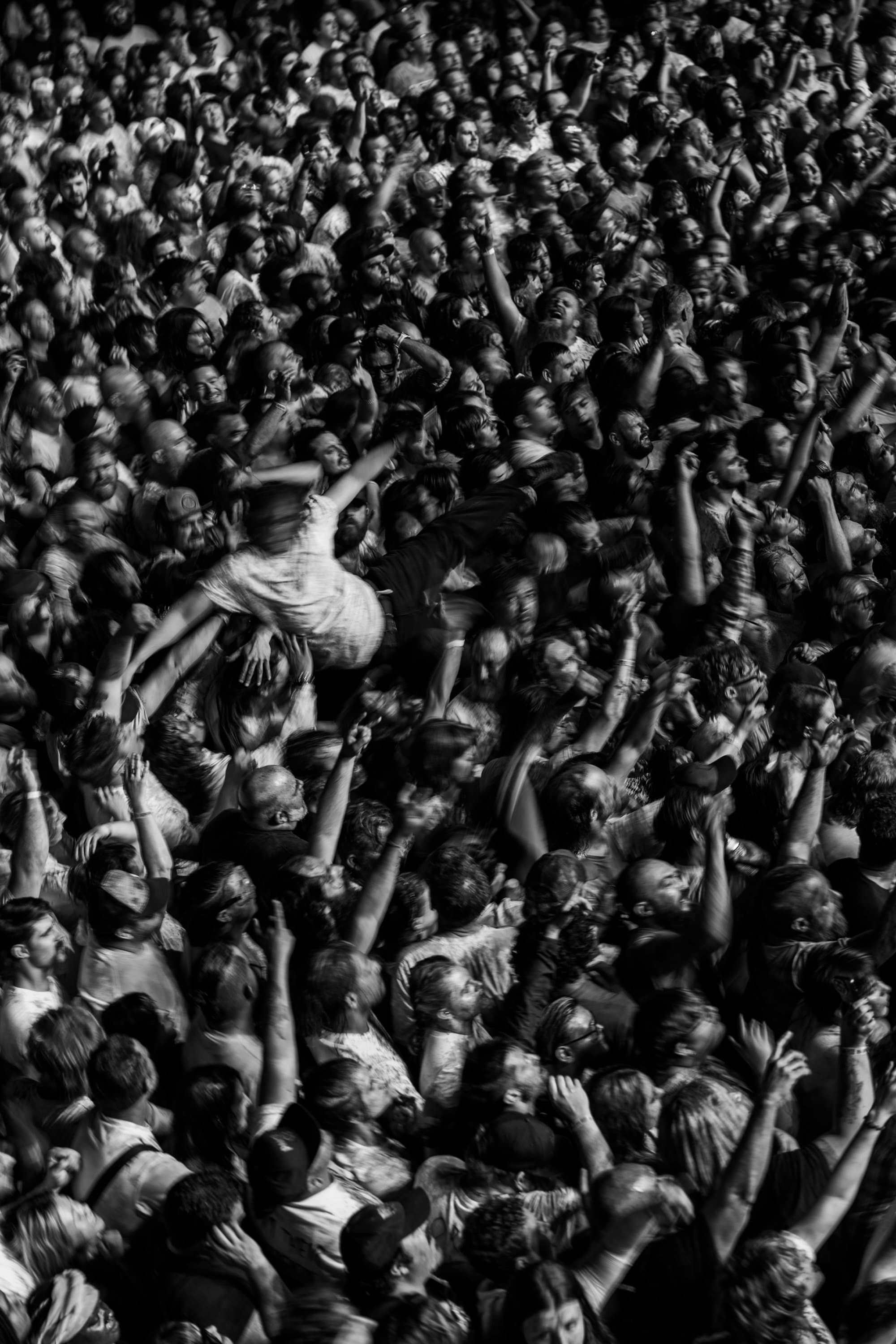 Black and white photograph of a packed concert crowd