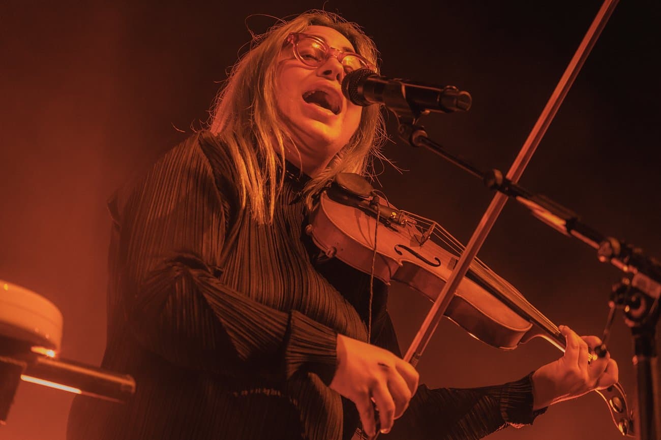Violinist performing under warm stage lights
